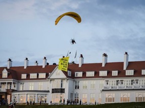 Greenpeace flies a paraglider over Turnberry as Donald Trump visits his Scottish golf course.