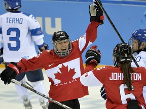 Canada's Jayna Hefford (left) celebrates her goal with teammate Rebecca Johnston at the Sochi Olympics Monday, February 10, 2014 in Sochi, Russia. (THE CANADIAN PRESS/Adrian Wyld)