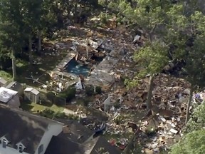 This aerial image taken from video provided by WPVI shows debris covering the ground after a house exploded on Saturday, July 7, 2018 in Newfield, N.J.
