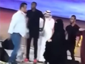 In a video circulating on social media, an unnamed woman was arrested after hugging singer Majid Almohandis during a concert in Saudi Arabia. (YouTUbe/Dinamalar)