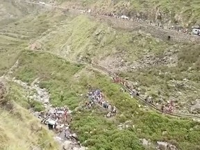 In this grab made from video provided by KK Productions, shows the area of a deadly bus accident in Uttarakhand's Paudi Garhwal district, northern India, Sunday, July 1, 2018.