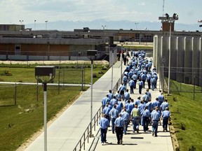 In this June 15, 2010 file photo, inmates walk to the dining hall from their cell block at the Idaho State Correctional Institution outside Boise, Idaho.