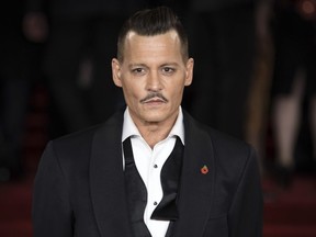 FILE - In this Nov. 2, 2017 file photo, actor Johnny Depp poses at the world premiere of the film "Murder on the Orient Express", in London.