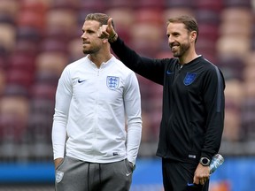 England's midfielder Jordan Henderson (left) and England's coach Gareth Southgate inspect the pitch of the Luzhniki Stadium in Moscow on July 10, 2018, on the eve of their World Cup semifinal football match against Croatia. (AFP/PHOTO)