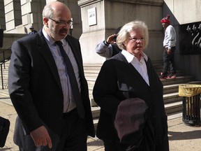 In this April 3, 2015, file photo, Episcopal Bishop Heather Cook leaves Baltimore City Circuit Court in Baltimore with attorney Jose Moline after her arraignment. (AP Photo/Juliet Linderman, File)