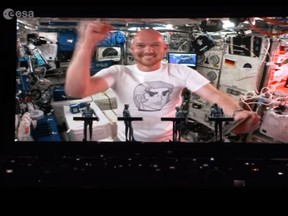 German ISS astronaut Alexander Gerst is seen on a video screen during a concert of the electric band 'Kraftwerk' at the Schlossplatz in Stuttgart, southern Germany on July 20, 2018. (ESA/YouTube screengrab)
