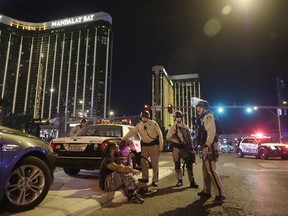 In this Oct. 1, 2017 file photo, police officers stand at the scene of a mass shooting near the Mandalay Bay resort and casino in Las Vegas.