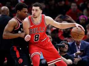Chicago Bulls guard Zach LaVine, right, drives against Toronto Raptors guard Kyle Lowry during the first half of an NBA basketball game Feb. 14, 2018, in Chicago.