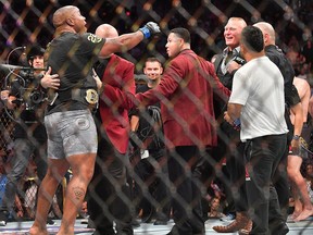 Daniel Cormier (L) challenges Brock Lesnar (R) after winning his heavyweight championship fight against Stipe Miocic at T-Mobile Arena on July 7, 2018 in Las Vegas.