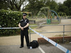 A British police officer guards a cordon outside the Queen Elizabeth Gardens park in Salisbury, England, Wednesday, July 4, 2018. British police have declared a "major incident" after two people were exposed to an unknown substance in a town near where a former Russian spy and his daughter were poisoned with nerve agent.