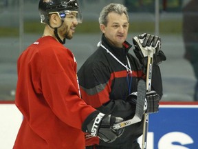 Calgary Flames Captain Jarome Iginla chats with Coach Darryl Sutter.