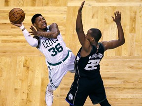 Boston Celtics guard Marcus Smart (36) is fouled by Milwaukee Bucks forward Khris Middleton (22) in Boston, Tuesday, April 24, 2018. (AP Photo/Charles Krupa)