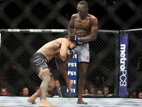 Brad Tavares, left, attempts to take down Israel Adesanya in The Ultimate Fighter 27 Finale middleweight main event bout at the Palms casino-hotel in Las Vegas, Friday, July 6, 2018.