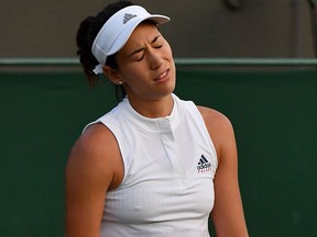 Spain's Garbine Muguruza reacts against Belgium's Alison Van Uytvanck during their women's singles second round match on the fourth day of the 2018 Wimbledon Championships at The All England Lawn Tennis Club in Wimbledon, southwest London, on July 5, 2018.
