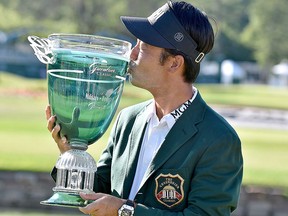 Kevin Na kisses the trophy after winning the Military Tribute PGA Tour Golf Tournament at the Greenbrier  Sunday, July 8, 2018, in White Sulphur Springs, W. Va.