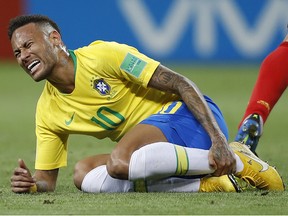Brazil's Neymar holds his shinbone during the quarterfinal match against Belgium at the 2018 World Cup in the Kazan Arena, in Kazan, Russia, Friday, July 6, 2018. (AP Photo/Francisco Seco)
