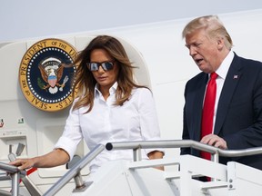 U.S. President Donald Trump and first lady Melania Trump arrive on Air Force One at Morristown Municipal Airport, in Morristown, N.J., Friday, July 27, 2018, en route to Trump National Golf Club in Bedminster, N.J.