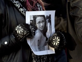 A woman holds a photo as several hundred people attend a community vigil to remember Rehtaeh Parsons at Victoria Park in Halifax on Thursday, April 11, 2013. (THE CANADIAN PRESS/Andrew Vaughan)