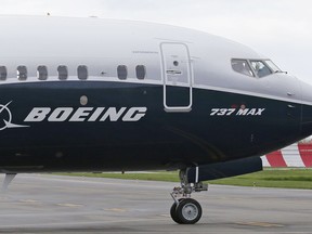 In this April 13, 2017, file photo, a pilot waves from the flight deck of a Boeing 737 MAX 9 as it rolls out for the airplane's first flight, in Renton, Wash.