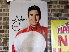 Signs, including one featuring Papa John's founder John Schnatter, at a Papa John's pizza store in Quincy, Mass. on Dec. 21, 2017. (AP Photo/Charles Krupa)