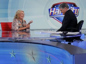 Roseanne Barr talks with Fox News talk show host Sean Hannity while being interviewed during a taping of his show, Thursday, July 26, 2018, in New York. (AP Photo/Julie Jacobson)