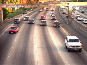 A white Ford Bronco, driven by Al Cowlings and carrying O.J. Simpson, is trailed by police cars as it travels on a southern California freeway in Los Angeles on June 17, 1994. (AP Photo/Joseph R. Villarin)