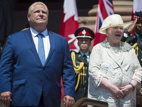 Ontario Premier Doug Ford and Lt.-Gov. Elizabeth Dowdeswell sing the national anthem during the public swearing-in ceremony at Queen's Park in Toronto on June 29, 2018.