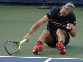 Benoit Paire smashes his racket after losing to Marcos Baghdatis during the first round of the Citi Open, Tuesday, July 31, 2018, in Washington. (AP Photo/Carolyn Kaster)