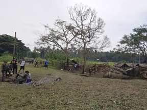 Government forces inspect the site of an explosion in Lamitan, Basilan province, southern Philippines on Tuesday, July 31, 2018. (AP Photo/Christine Garcia)