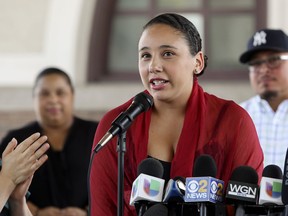 Mia Irizarry speaks at a news conference in Chicago, Friday, July 13, 2018, about an incident where a man confronted her about a T-shirt she wore emblazoned with the Puerto Rican flag at a Chicago forest preserve on June 14.