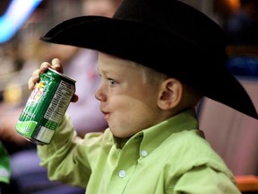 A young rodeo fan takes a drink of Canada Dry during day two action of the 41st Canadian Finals Rodeo at Rexall Place on Thursday Nov. 6, 2014. (Hugo Sanchez/Special to the Edmonton Sun)
