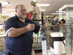 In this May 2, 2018 file photo, Blockbuster Alaska general manager Kevin Daymude moves a display case featuring the jockstrap worn by actor Russell Crowe in the 2005 movie "Cinderella Man" at a Blockbuster video store in Anchorage, Alaska.