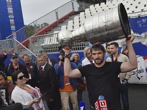 Washington Capitals star Alex Ovechkin holds the Stanley Cup trophy at the fan zone in Moscow ahead of the the quarterfinal match between Russia and Croatia at the 2018 World Cup in Sochi, Russia, Saturday, July 7, 2018.