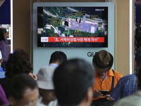 A TV screen shows a satellite image of North Korea's Sohae launch site, during a news program at the Seoul Railway Station in Seoul, South Kore, Tuesday, July 24, 2018. (AP Photo/Ahn Young-joon)