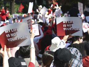 Woman protesters stage a rally to demand stronger government action to fight the spread of intimate photos and footage taken by hidden cameras, which they say have women living in constant anxiety and distress, in Seoul, South Korea, Saturday, July 7, 2018.