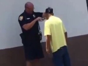 In a viral video, a Florida police officer helps shave the beard of a homeless man in hopes of helping him get a job at McDonald's. (Facebook/City of Tallahassee Police Department)