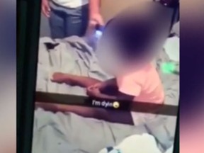 A one-year-old girl is seen in this screengrab of a Snapchat video being taunted by a teen girl.