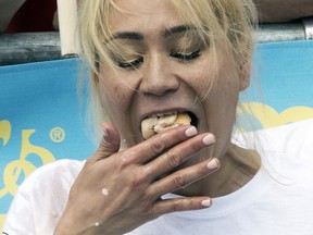 Miki Sudo eats hot dogs during the women's competition of the Nathan's Famous Fourth of July hot dog eating contest, Wednesday, July 4, 2018, in New York's Coney Island. (AP Photo/Mary Altaffer)