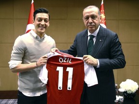Turkey's President Recep Tayyip Erdogan, right, poses for a photo with Arsenal soccer player Mesut Ozil in London on Sunday, May 13, 2018. (Presidential Press Service/Pool via AP, File)