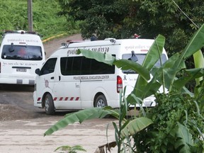 Two ambulances arrive near the cave to wait for more evacuations of the boys and their soccer coach who have been trapped since June 23, in Mae Sai, Chiang Rai province, northern Thailand Monday, July 9, 2018. Thailand's interior minister says the same divers who took part in Sunday's rescue of four boys trapped in a flooded cave will also conduct the next operation as they know the cave conditions and what to do.