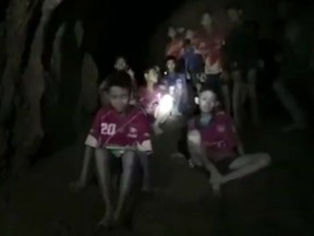 In this grab taken from video provided by the Thai Navy Seal, a view of the boys and their soccer coach as they are rescued in a cave, in Chiang Rai in Thailand, Monday, July 2, 2018.  (Thai Navy Seal via AP)