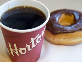 A coffee and donut from Tim Hortons is seen at a Coquitlam B.C., location on April 26, 2018. Tim Hortons has signed an exclusive master franchise joint venture agreement with Cartesian Capital Group to develop and open more than 1,500 Tim Hortons restaurants throughout China over the next 10 years.