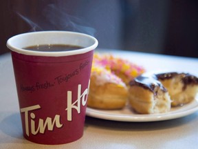 A coffee and donut from Tim Horton's is seen at a Coquitlam, B.C., location on April 26, 2018. Some Canadians craving a doughnut or double-double but strapped for time can now have Tim Hortons food brought to them as the national chain recently started testing delivery this week.