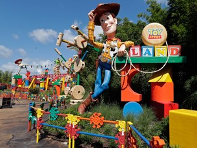 Sheriff Woody greets visitors at the entrance Toy Story Land in Disney's Hollywood Studios at Walt Disney World in Lake Buena Vista, Fla. (AP Photo/John Raoux)