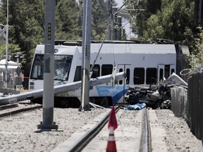 Two people are dead after a car and a light rail collided near Lincoln and Auzerais avenues in San Jose, Calif., on Sunday, July 8, 2018. The northbound train of the Santa Clara Valley Transportation Authority (VTA) went off the track after it hit the car with at least two individuals inside and pulled the car along the track for several meters. Police said the driver was trying to drive around the railway crossing arms, which were lowered down and functioning normally.