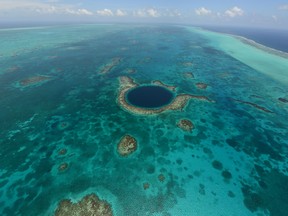 An aerial view of the Great Blue Hole, a popular diving site that is part of Belize’s barrier reef. (AP Photo/Belize Tourist Board)
