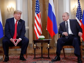 U.S. President Donald Trump, left, gives a statement as Russian President Vladimir Putin looks on at the beginning of a meeting at the Presidential Palace in Helsinki, Finland, Monday, July 16, 2018.