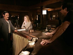 Actors Ian McShane, who portrays Al Swearengen, left, and Paula Malcomson, who portrays Trixie, center, on the set with David Milch, creator of the HBO series "Deadwood," in Santa Clarita, Calif. on Feb. 9, 2005. (AP Photo/Kevork Djansezian)