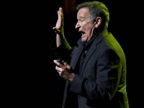 FILE - In this Nov. 8, 2012 file photo, Robin Williams performs at the 6th Annual Stand Up For Heroes benefit concert for injured service members and veterans in New York. A new documentary on Williams tells the late comedian's story mostly using his voice. The documentary, which includes interviews with David Letterman and Billy Crystal, premiered Monday, July 16, 2018, on HBO and is available on its streaming service, HBO Now.