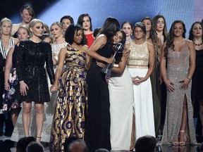 Jennifer Garner, front, embraces gymnast Aly Raisman after presenting the Arthur Ashe Award for Courage, at the ESPY Awards at Microsoft Theater on Wednesday, July 18, 2018, in Los Angeles. (Photo by Phil McCarten/Invision/AP)